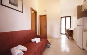 a living room with a couch with towels on it at Beautiful Apartment In Costa Rei -Ca- With Wifi in Monte Nai