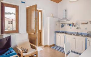 a kitchen with white cabinets and a sink and a table at Casa Pirato in Modica
