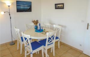 a dining room with a white table and chairs at Amazing Apartment In Collioure in Collioure +15 photos