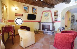 a living room with a fireplace and a tv at Villa Aquaro in Ogliastro Cilento