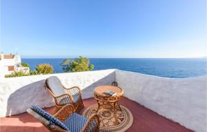 two chairs and a table on a balcony overlooking the ocean at Villa Antica in Stalettì