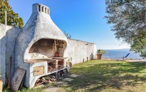 a pizza oven sitting next to a wall at Villa Antica in Stalettì +16 photos