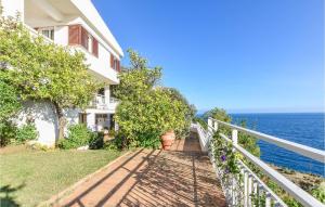 a white house with a balcony and the ocean at Villa Antica in Stalettì