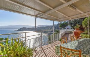 an outdoor balcony with a view of the water at Villa Antica in Stalettì