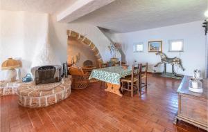 a living room with a table and a fireplace at Villa Antica in Stalettì