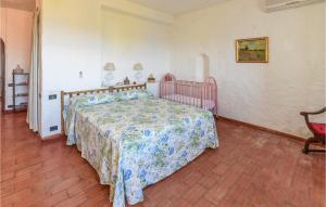 a bedroom with a bed with a floral bedspread at Villa Antica in Stalettì