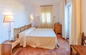 a bedroom with a bed and a table and a window at Villa Antica in Stalettì