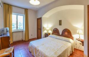 a bedroom with a bed and a tv and a window at Villa Antica in Stalettì