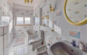 a bathroom with a sink and a toilet and a mirror at Villa Antica in Stalettì