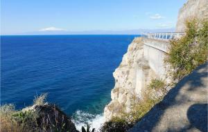 a view of the ocean from the side of a cliff at Stunning Home In Saline Ioniche in Saline Joniche +26 photos
