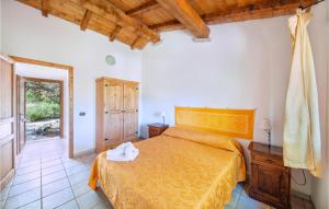a bedroom with a bed with a yellow bedspread at Ginepri Bilo in Badesi