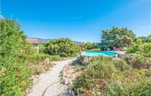 a path leading to a swimming pool on a hill at Ginepri Bilo in Badesi +11 photos