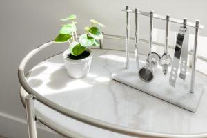 a white table with a potted plant and utensils at Colorful Western Vibe - Pet-Friendly - Zuni Lofts in Denver +32 photos