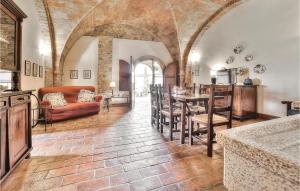 a kitchen and living room with a table and chairs at Vincenzo-podere Moricci in Montaione