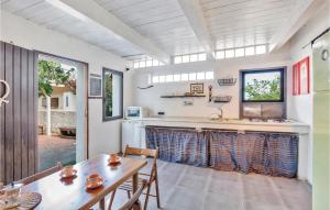 a kitchen with a wooden table and a table and chairs at Casa Stranges in Copanello