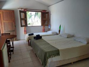 Кровать или кровати в номере Arco Mundial Taíba
