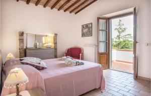a bedroom with a bed and a large window at L'ortale in Pitigliano
