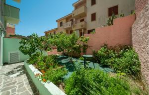 a garden in front of a building at Amazing Apartment In La Maddalena With 1 Bedrooms in La Maddalena