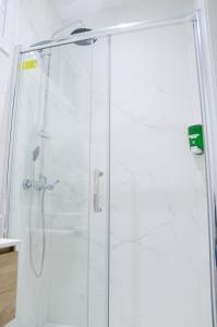 a shower with a glass door in a bathroom at Sagrada Familia Comfy apartment in Barcelona