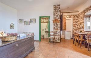 a kitchen and dining room with a table and chairs at Gorgeous Apartment In Gioiosa Marea Me With House Sea View in San Giorgio