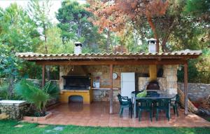 a outdoor kitchen with a table and chairs on a patio at Caprice in Míloi