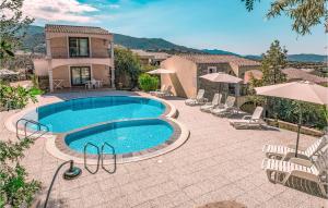 a swimming pool in front of a house at Mono 2 in Badesi +9 photos