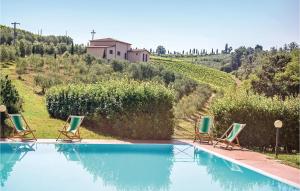a swimming pool with three lawn chairs and a house at Casale Del Borgo 6 in Querce