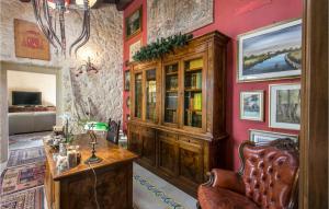 a living room with a wooden cabinet and a table at Tenuta Santa Lucia in Noto