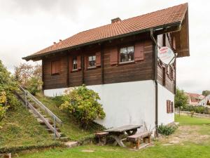 a building with a bench in front of it at Wooden holiday home in Hinterrod with sauna in Einsiedel