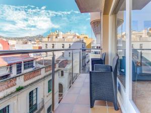 a balcony with chairs and a view of the city at Belvilla by OYO Apartment in Lloret de Mar in Lloret de Mar