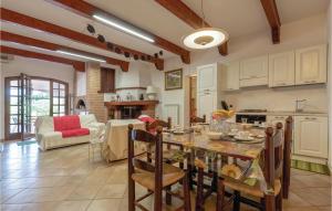a kitchen and living room with a table and chairs at Nice Apartment In Perugia -pg- With Outdoor Swimming Pool in Ponte Felcino