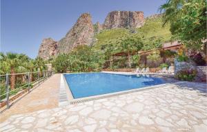 a swimming pool with a mountain in the background at Lovely Home In Makari-S Vito Lo Capo in Macari +6 photos