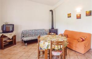 a living room with a couch and a table and a stove at Casa Nella Prateria in Giarratana
