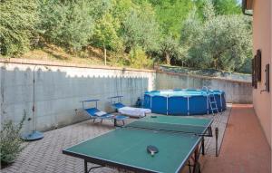 two ping pong tables and chairs on a patio at Casa The Rose in Giampierone