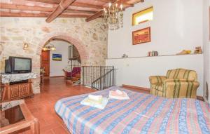 a bedroom with a bed and a tv in a room at Itaca in Massa Marittima