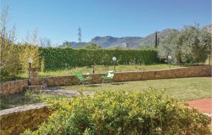 a garden with two chairs and a table with mountains in the background at Casa Antonio in Mandra Capreria +8 photos
