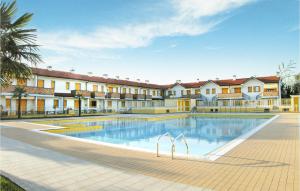 a large swimming pool in front of a building at Solmare B in Rosolina