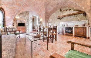 a living room with a table and a kitchen at Alessandro - Podere Moricci in Montaione