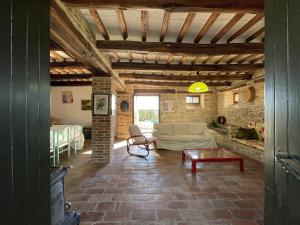 a living room with a couch and a table at Countryside Villa in Amandola with Swimming Pool in Amandola