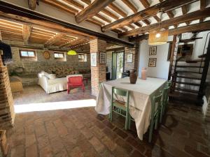 a living room with a table and a couch at Countryside Villa in Amandola with Swimming Pool in Amandola
