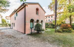 a pink house with a tree in front of it at 3 Bedroom Gorgeous Home In Vittorio Veneto Tv in Vittorio Veneto