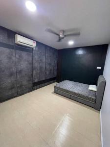 a room with a bed and a ceiling fan at Galaxy House with seaview balcony- JB PONTIAN in Pontian Kecil