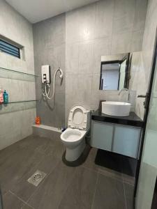 a bathroom with a toilet and a sink at Galaxy House with seaview balcony- JB PONTIAN in Pontian Kecil