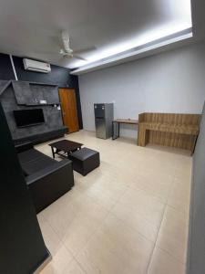 an empty room with a room with a table and a couch at Galaxy House with seaview balcony- JB PONTIAN in Pontian Kecil
