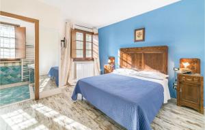 a blue bedroom with a bed and a bathroom at Il Vigneto in Brufa