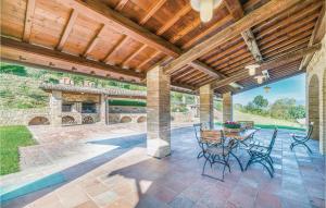 a patio with a table and chairs and a wooden ceiling at Il Vigneto in Brufa +21 photos