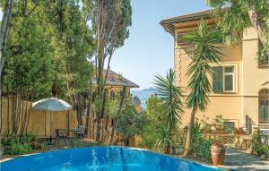 a house with a swimming pool in front of a house at Orchidea in San Michele di Pagana