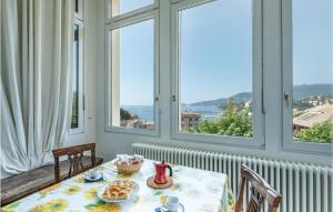 a table with a plate of food on a room with windows at Orchidea in San Michele di Pagana +9 photos