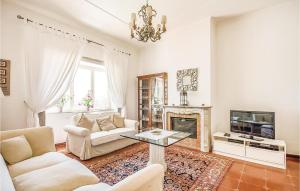 a living room with white furniture and a fireplace at Stunning Home In Roma With Jacuzzi in La Storta