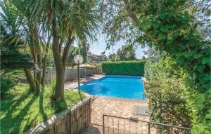 a swimming pool in a yard with trees and a fence at La Magnolia in Anguillara Sabazia